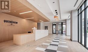 Toronto (Stonegate-Queensway) condo for rent - The lobby of a building with a reception desk and a checkered floor.