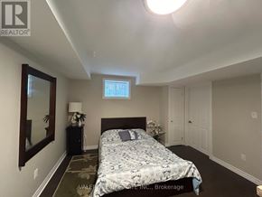 Mississauga (Churchill Meadows) apartment for rent - A bedroom with a bed, nightstand, and mirror.