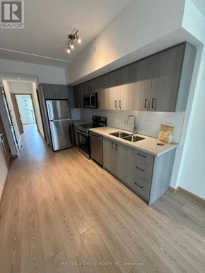 Toronto (Tam O'shanter-Sullivan) townhouse for rent - A kitchen with wooden floors and a sink.