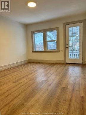 Windsor apartment for rent - A room with wooden floors and a white door.