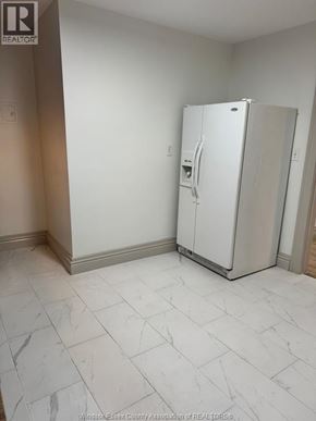 Windsor apartment for rent - A white refrigerator in a room with a tile floor.
