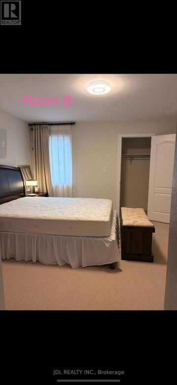 Newmarket (Stonehaven-Wyndham) apartment for rent - A bedroom with a bed, nightstand, and window.