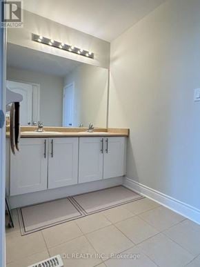 Newmarket (Stonehaven-Wyndham) apartment for rent - A bathroom with a mirror, sink, and cabinets.