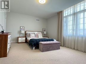 Newmarket (Stonehaven-Wyndham) apartment for rent - A bedroom with a bed, nightstand, and window with curtains.