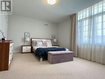 Newmarket (Stonehaven-Wyndham) apartment for rent - A bedroom with a bed, nightstand, and window with curtains.