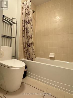 Newmarket (Stonehaven-Wyndham) apartment for rent - A white toilet sits next to a bathtub in a bathroom.