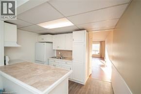 Niagara Falls townhouse for rent - A kitchen with white cabinets and a countertop is shown.