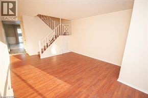 Niagara Falls townhouse for rent - A wooden floor in a room with a staircase.