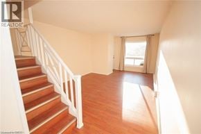 Niagara Falls townhouse for rent - A room with a staircase leading to the upper floor.