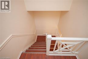Niagara Falls townhouse for rent - A staircase with a white railing and wooden steps.