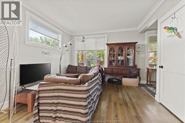 Windsor apartment for rent - A living room with a striped sofa and a television.