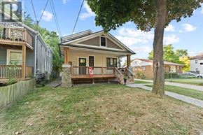 Windsor apartment for rent - A house with a porch and a tree in front.