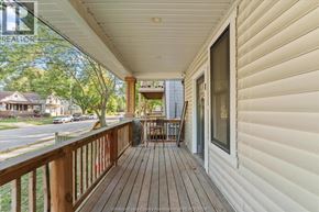 Windsor apartment for rent - A white house with a wooden deck and a glass door.