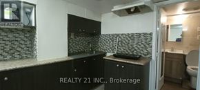 Toronto (Clairlea-Birchmount) apartment for rent - A bathroom with a black counter top and a mirror above it.