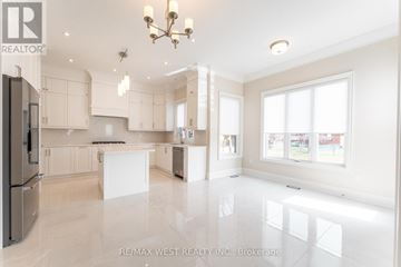 Toronto (Maple Leaf) apartment for rent - A spacious kitchen with white cabinets and a large island.