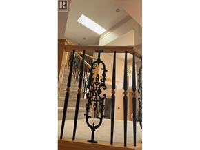 Richmond apartment for rent - A staircase with a black wrought iron railing.