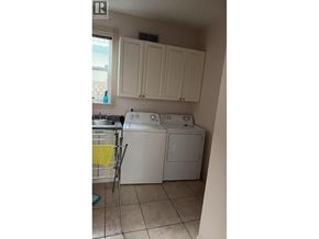 Richmond apartment for rent - A small laundry room with a washer and dryer.