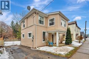 Brantford apartment for rent - A two-story house with a beige siding and a satellite dish on the roof.