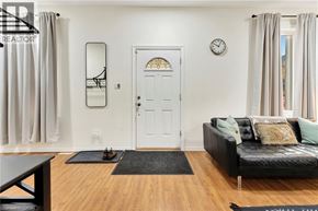 Brantford apartment for rent - A living room with a black couch and a white door.
