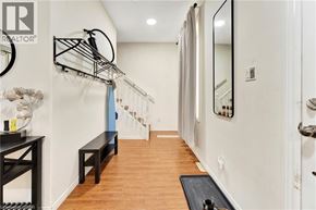 Brantford apartment for rent - A hallway with a bench and a coat rack.