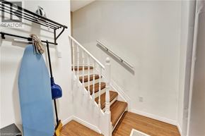 Brantford apartment for rent - A staircase with a white railing and wooden steps.