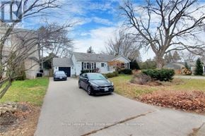 Burlington (Lasalle) apartment for rent - A car is parked in front of a house with a garage.