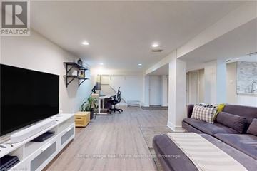 Burlington (Lasalle) apartment for rent - A living room with a grey couch and a television.