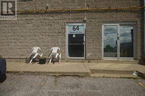 Bradford West Gwillimbury (Bradford) apartment for rent - Two white chairs are placed on the sidewalk outside a building.