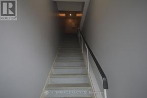 Bradford West Gwillimbury (Bradford) apartment for rent - A staircase with a metal railing and steps leading to a door at the end.