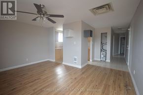 Bradford West Gwillimbury (Bradford) apartment for rent - A room with a ceiling fan and wooden flooring.