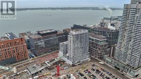 Toronto (Waterfront Communities) condo for rent - A cityscape with a body of water in the background and a construction site in the foreground.