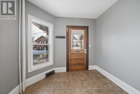 Orillia multi-family for rent - A room with a door and a window showing a snowy scene outside.