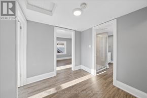 Orillia multi-family for rent - A spacious room with a doorway leading to another room.