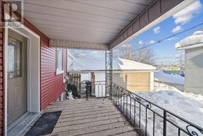 Orillia duplex for rent - A red house with a white door and a wooden deck.