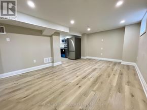 Hamilton (Inch Park) apartment for rent - A spacious room with wooden flooring and a kitchenette in the corner.