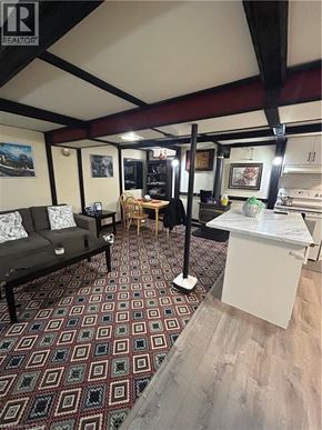Hamilton apartment for rent - A room with a patterned carpet and a white table.