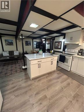 Hamilton apartment for rent - A kitchen with white cabinets and a wooden floor.