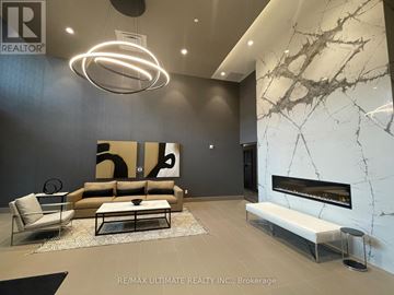 Milton (Walker) condo for rent - A modern living room with a fireplace and a large painting on the wall.