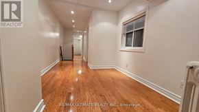 Toronto (Dovercourt-Wallace Emerson-Junction) apartment for rent - A long hallway with wood floors and white walls.