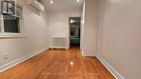 Toronto (Dovercourt-Wallace Emerson-Junction) apartment for rent - A room with wooden floors and a window with blinds.