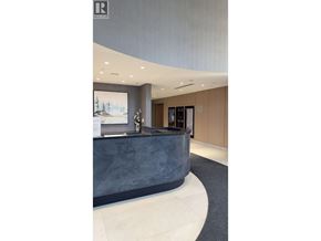 Vancouver apartment for rent - A reception area with a grey counter and a painting of a snowy scene on the wall.
