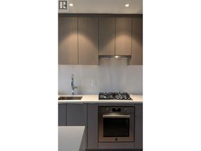 Vancouver apartment for rent - A modern kitchen with a stove, sink, and cabinets.