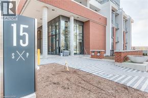 Kitchener condo for rent - A realtor sign is in front of a building.