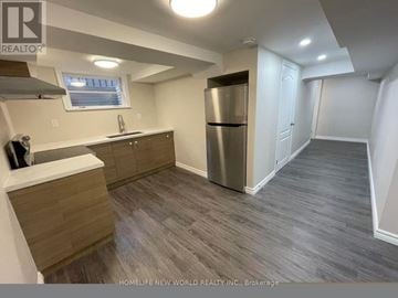 Richmond Hill (Crosby) apartment for rent - A kitchen with a refrigerator, cabinets, and a window.
