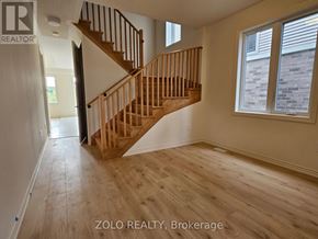 Cobourg apartment for rent - A wooden staircase in a room with a window.