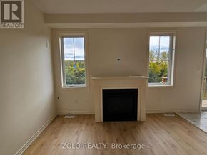 Cobourg apartment for rent - A living room with a fireplace and two windows.