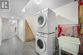 Guelph (Grange Road) apartment for rent - A laundry room with a washer and dryer stacked on top of each other.