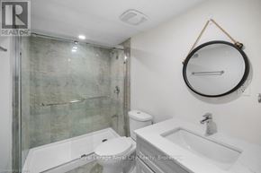 Guelph (Grange Road) apartment for rent - A bathroom with a toilet, sink, and shower.