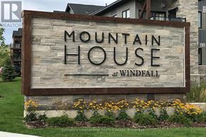 Blue Mountains condo for rent - A sign that says Mountain House at Windfall in front of a building.