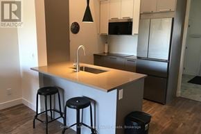 Blue Mountains condo for rent - A kitchen with a bar stool in front of a sink.